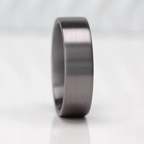 Men's 7mm wide flat court shape wedding ring crafted from tantalum, featuring a modern and durable design with a sleek matte finish—ideal for those seeking a unique and stylish alternative to traditional rings