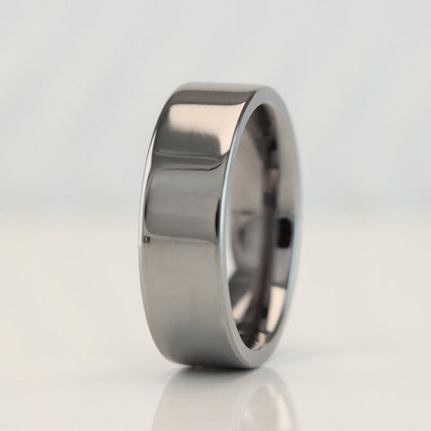 Flat court tantalum wedding ring with a polished finish, designed for ultimate comfort and durability. The sleek flat court shape offers a modern twist on a classic style, while the polished surface enhances the rich gunmetal blue-grey hue of tantalum, creating a contemporary yet timeless wedding band